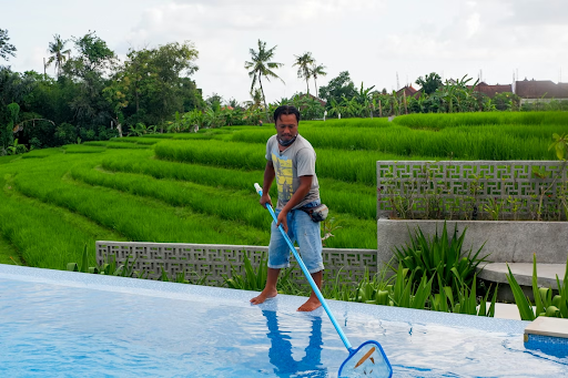 A man cleaning pool